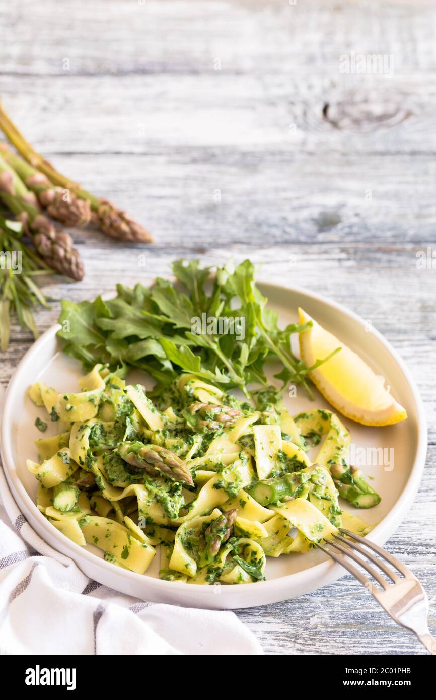 tagliatelle with spinach and asparagus. pasta with cream sauce and
