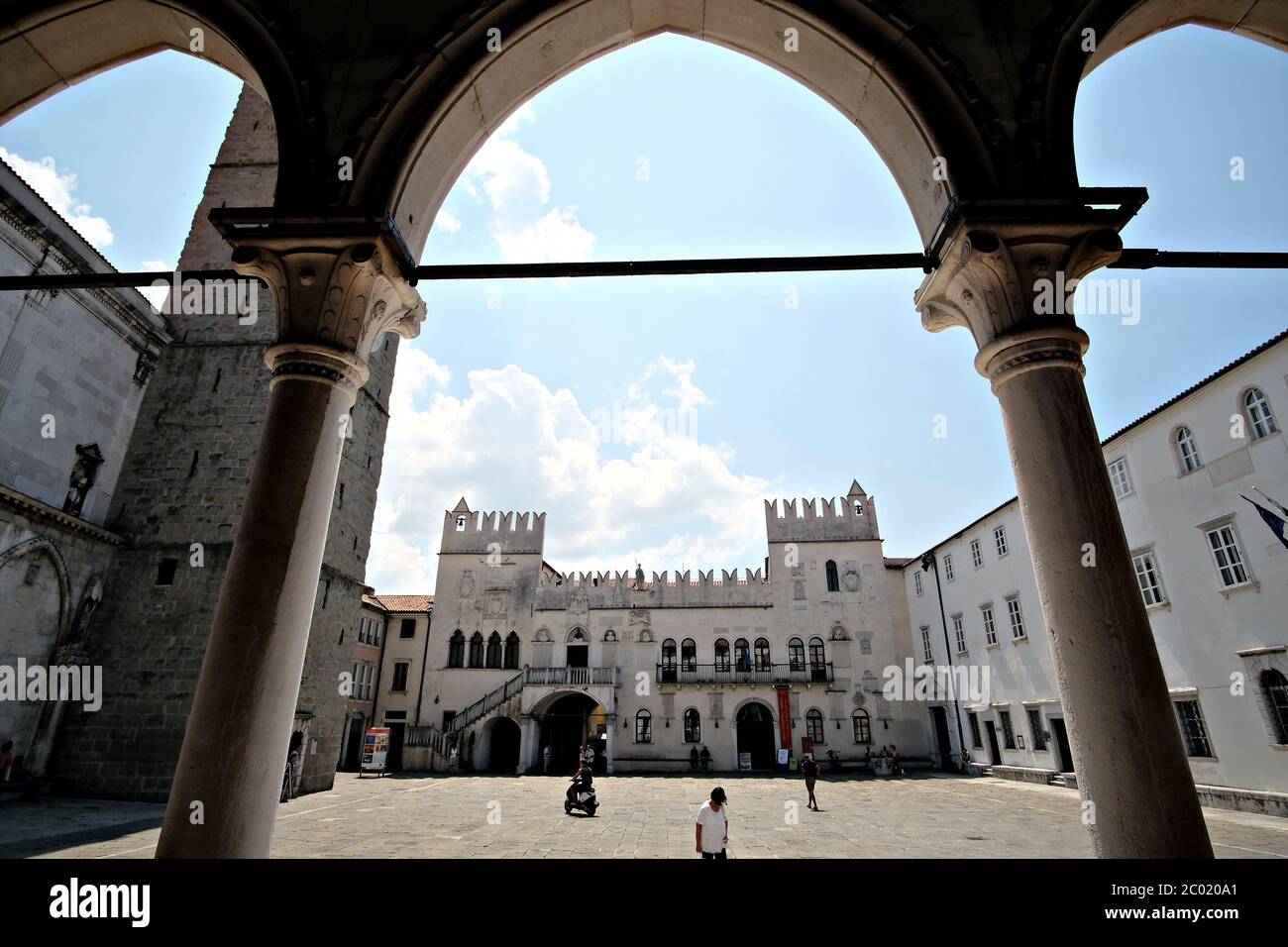 View of the Praetorian Palace in Tito square through the arcades of the Cafè Kavarna in Koper Stock Photo