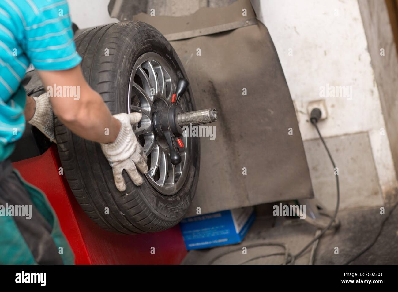 Wheel Balancing. Car wheel balance machine in auto repair Stock Photo