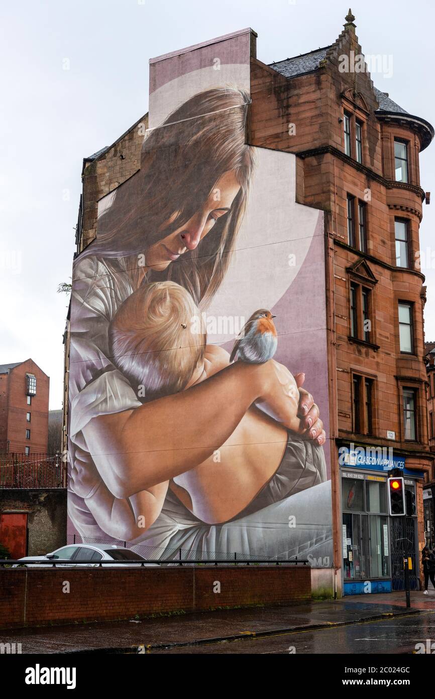 St Enoch and child mural by street artist Smug on gable end of building on the High Street in Glasgow, Scotland, UK Stock Photo