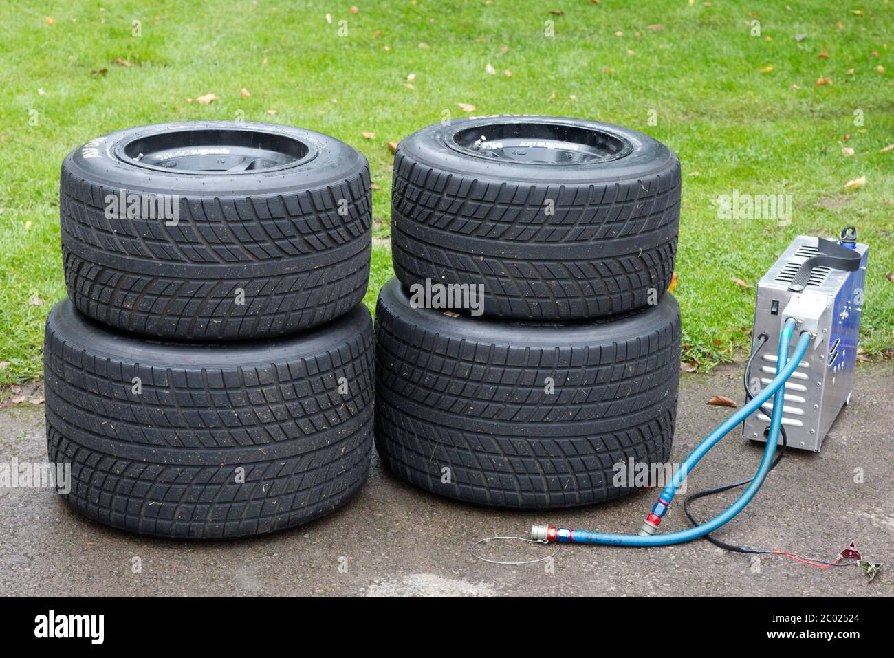 Racing tires and a portable air pump Stock Photo
