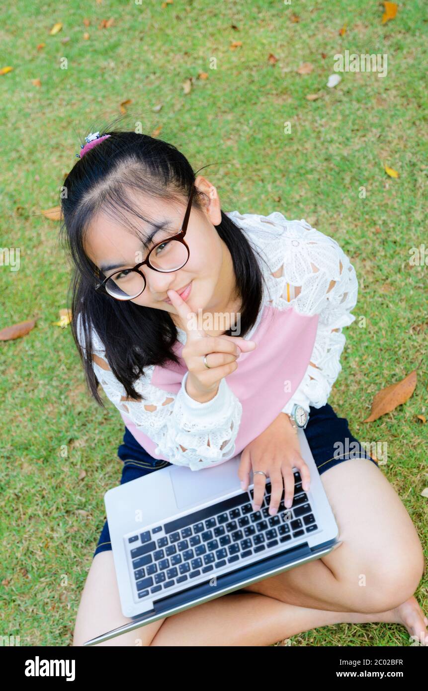 Lovely girl with a laptop on the grass Stock Photo - Alamy