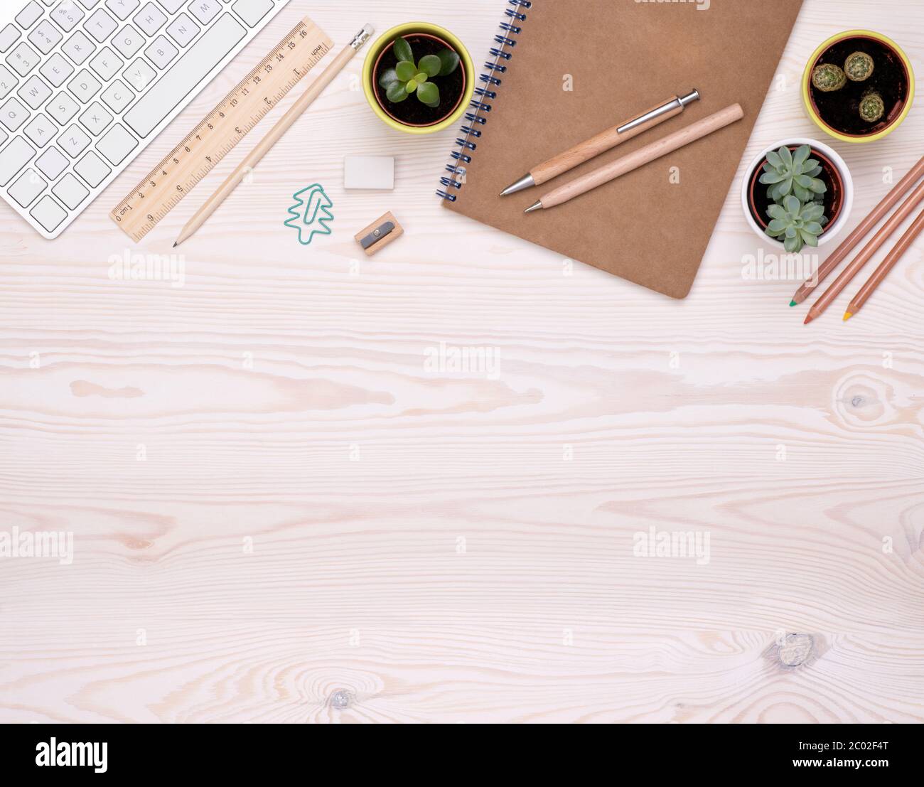 Desk top with eco friendly office supplies such as wooden pen, pencils and brown paper notebook with copy space Stock Photo