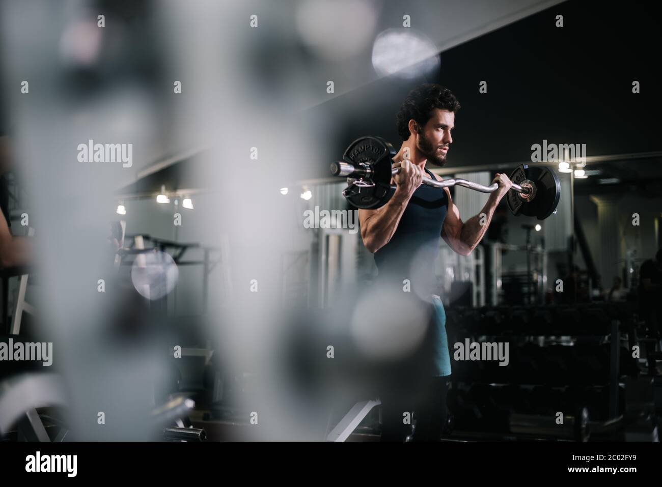 Athletic bearded young man with muscular wiry body wearing sportswear