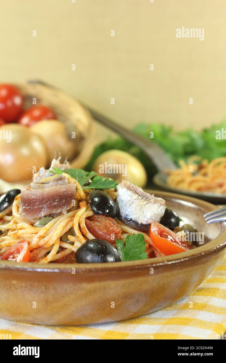 Spaghetti alla puttanesca with capers and anchovie Stock Photo