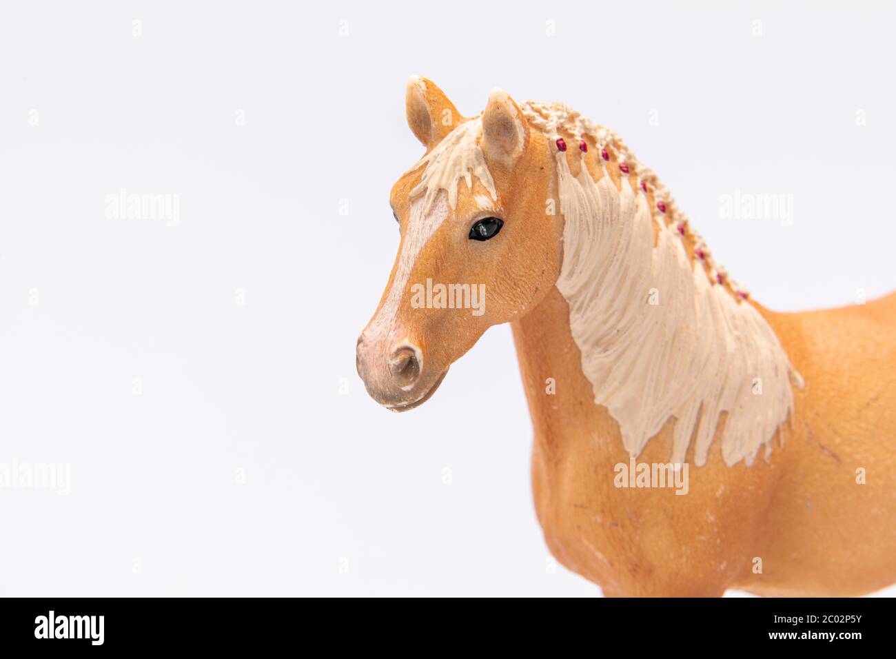 close up of a brown plastic horse head isolated on a white background