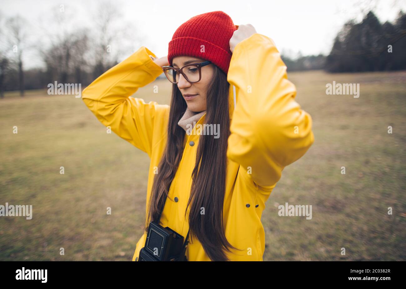 Young girl wearing yellow raincoat hires stock photography and images