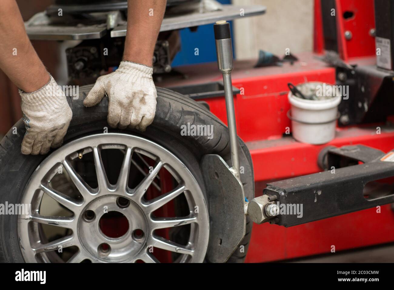 Mechanic changing car tire fitting. Wheel tyre repairing Stock Photo