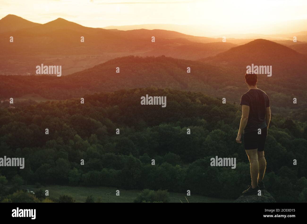 Silhouette of a man on the mountain at sunset Stock Photo - Alamy