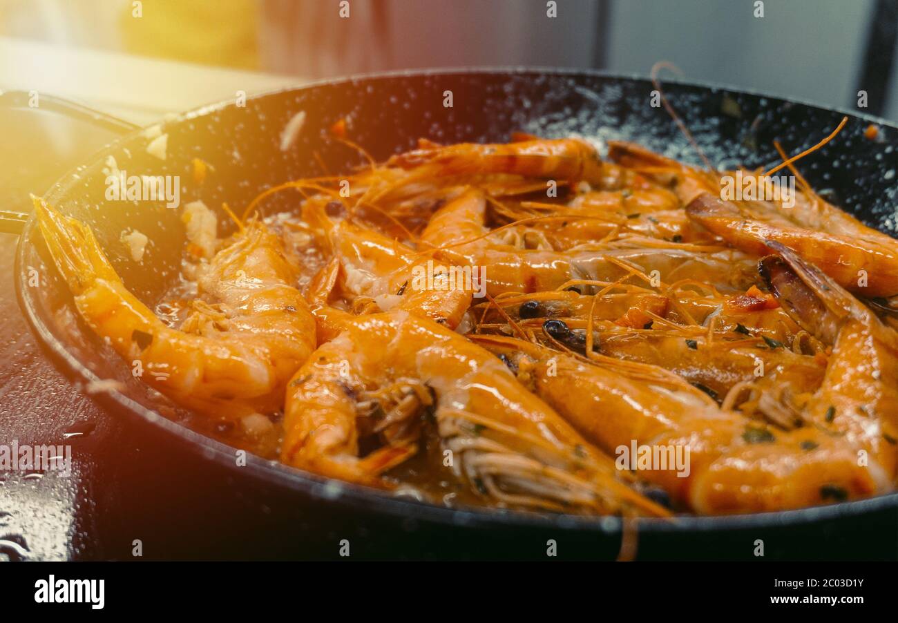 Chef cooking with Tiger prawn on background sun light efect Stock Photo