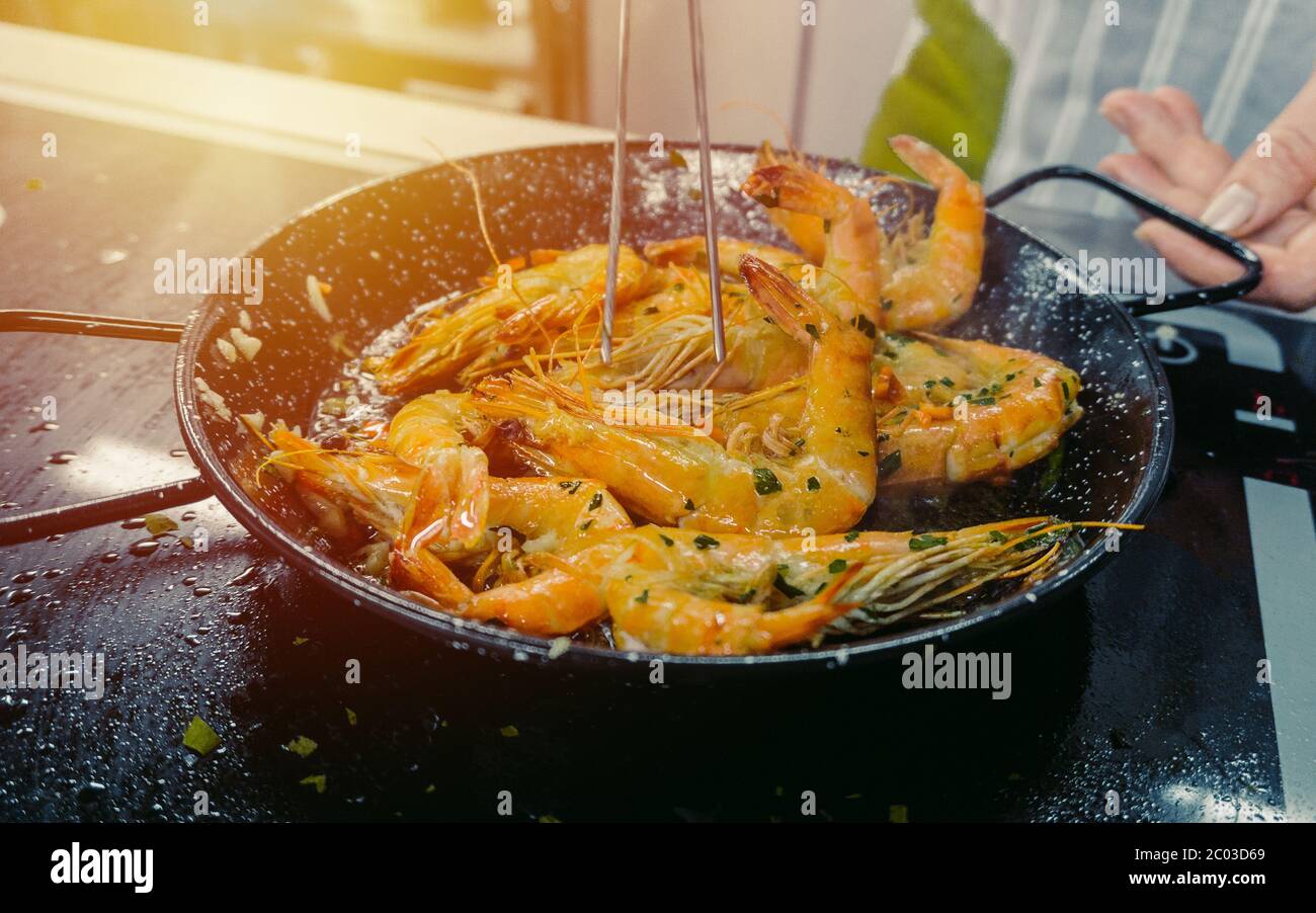 Chef cooking with Tiger prawn on background sun light efect Stock Photo