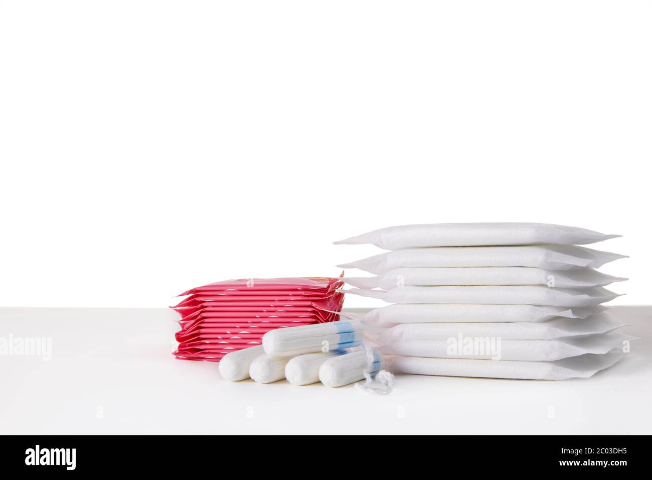 many menstrual sanitary pads and cotton tampons on white background. Feminine hygiene products Stock Photo