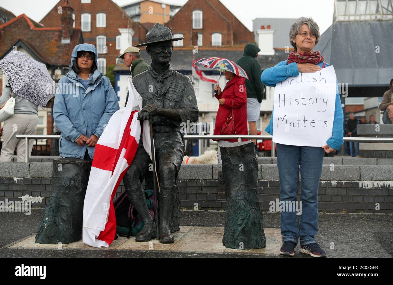 Locals show their support for a statue of Robert Baden-Powell on Poole Quay in Dorset ahead of its expected removal to 'safe storage' following concerns about his actions while in the military and 'Nazi sympathies'. The action follows a raft of Black Lives Matter protests across the UK, sparked by the death of George Floyd, who was killed on May 25 while in police custody in the US city of Minneapolis. Stock Photo