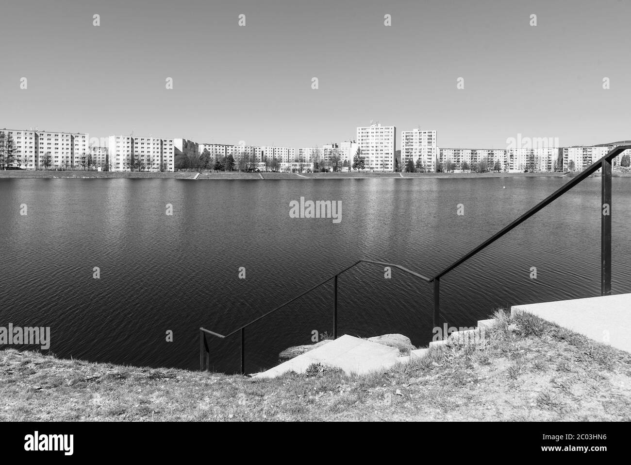 Housing estate at Mseno Reservoir. Blocks of flats at the water. Jablonec nad Nisou, Czech Republic. Black and white image. Stock Photo