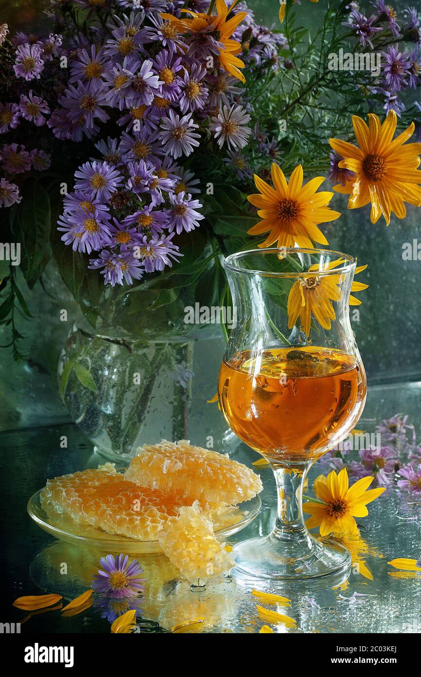 Still-life with white wine, honey and a bouquet Stock Photo - Alamy