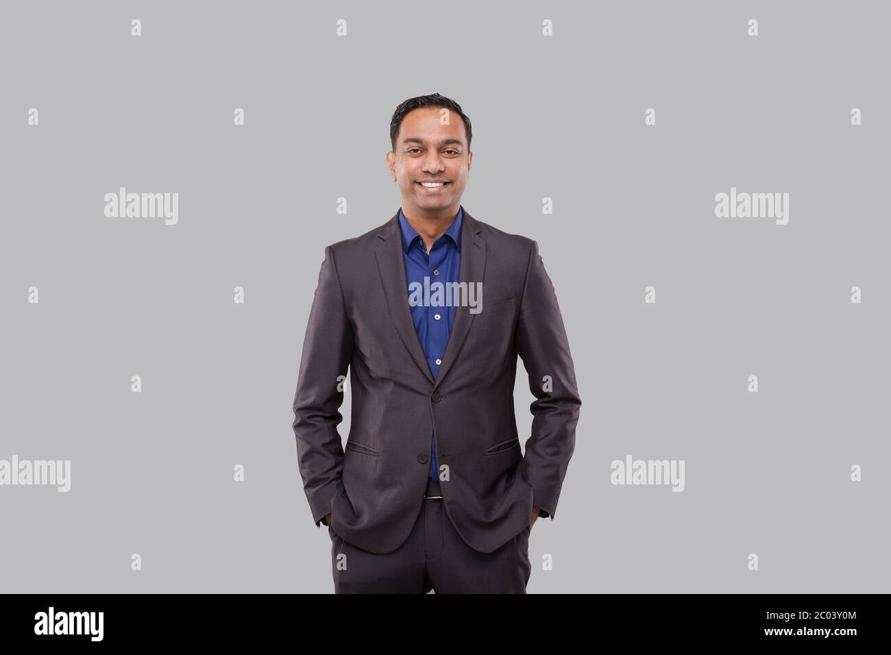 Businessman Hands in Pockets Isolated. Indian Man in Suit Stock Photo