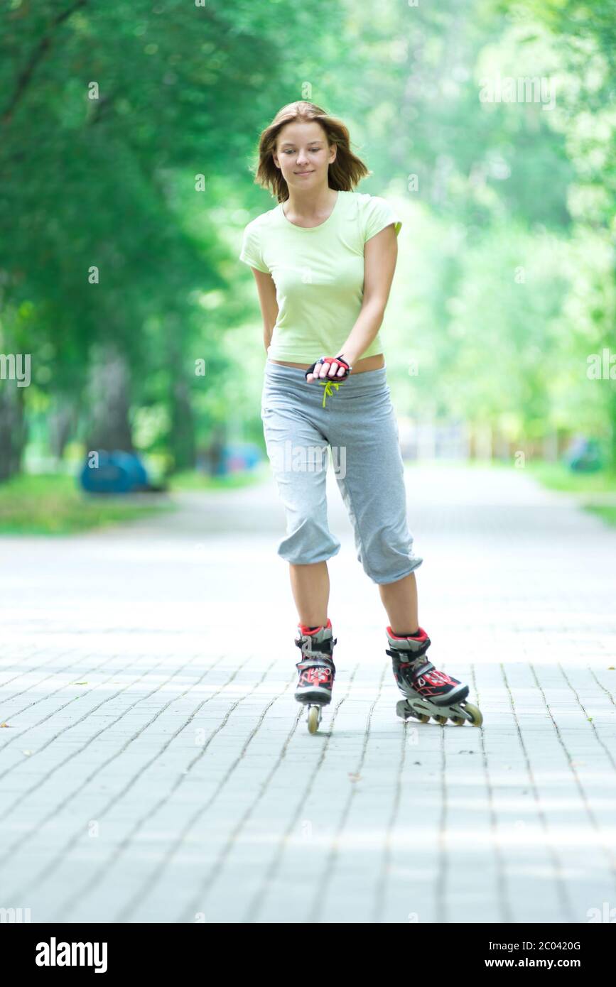 Roller skating sporty girl in park rollerblading on inline skate Stock Photo