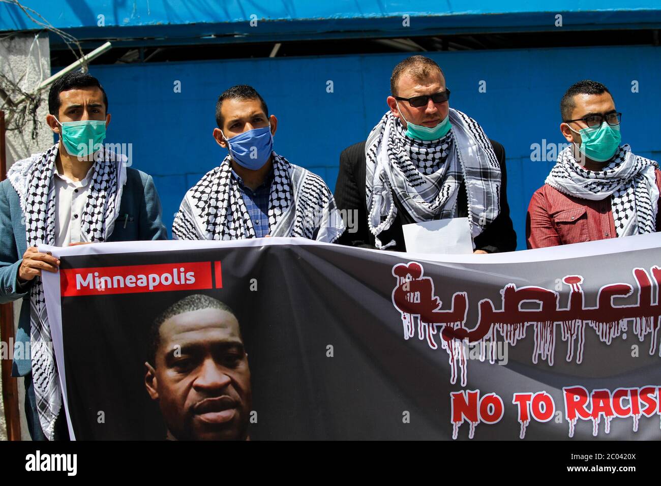 June 11, 2020: Gaza, Palestine. 11 June 2020. Palestinian hold a protest against racism outside the UN headquarters in Gaza City. Participants raised a big banner of George Floyd, recently killed by the police in Minneapolis, and Iyad al Halaq, killed by Israeli police in Jerusalem on 30 May. Israeli police killed Iyad on his way to school for holding a 'suspicious object'', despite knowing of his special needs. Palestinians are not optimistic that an enquiry will bring justice or will change what the B'Tselem organisation denounce as 'Israel's reckless open-fire policy, authorised by Stock Photo
