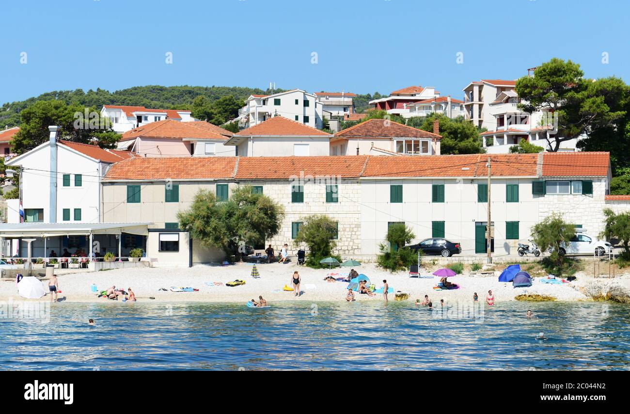 A small beach in a small town in the Kaštela-viken bay near Split, Croatia. Stock Photo