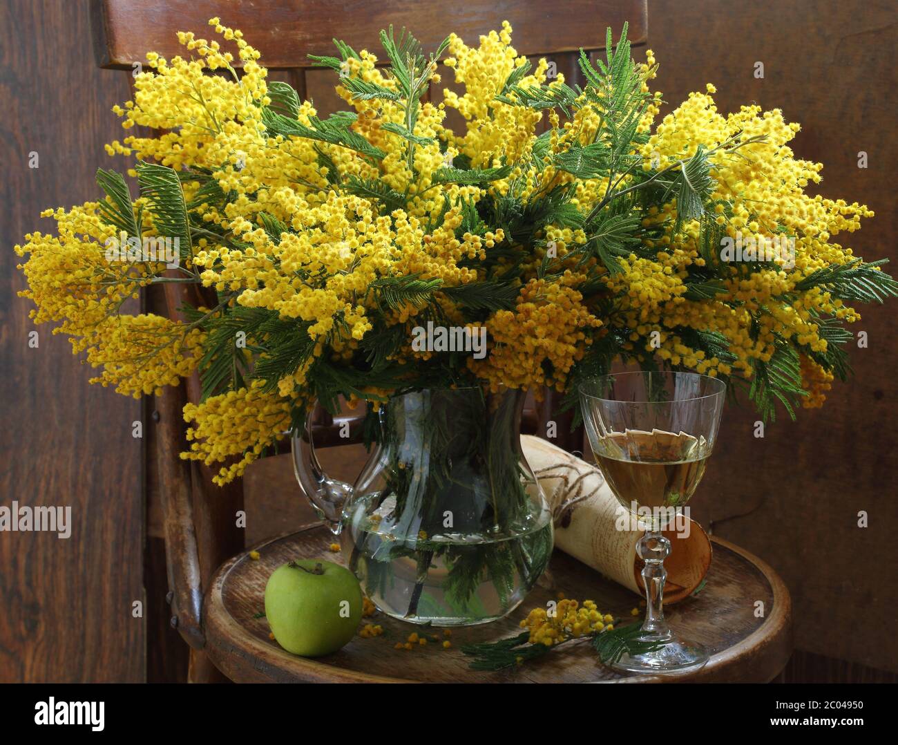 Still-life with wine and a mimosa bouquet Stock Photo - Alamy