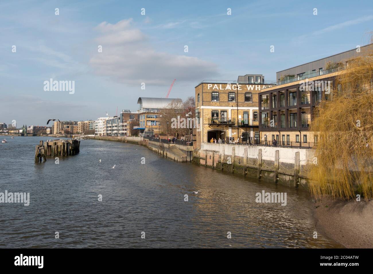 General view along the Thames Path and the north bank of the River Thames looking west in Fulham, London, UK. Stock Photo
