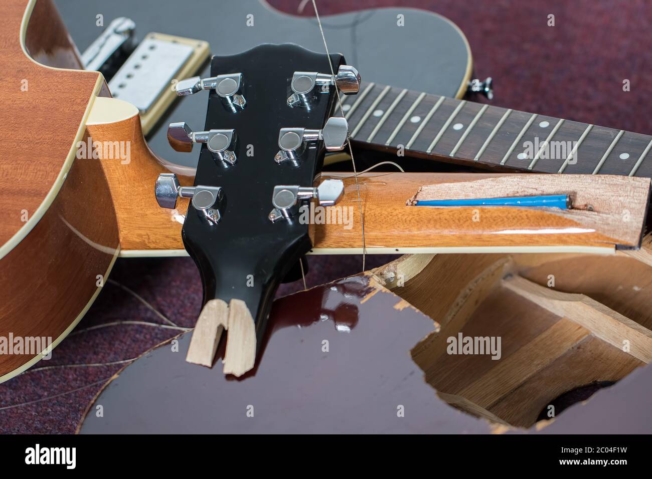 Smashed guitars. Pile of broken electric and acoustic guitar bits. Close-up  of damaged musical instruments including headstock, neck and body of vario  Stock Photo - Alamy