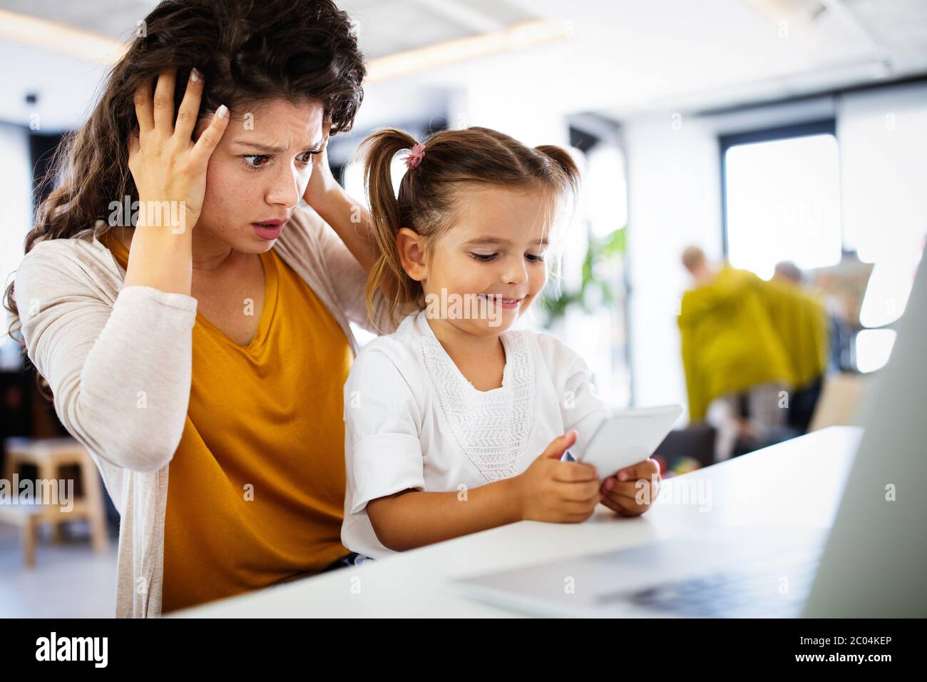 People, children, technology and addiction concept. Little girl with smartphones Stock Photo