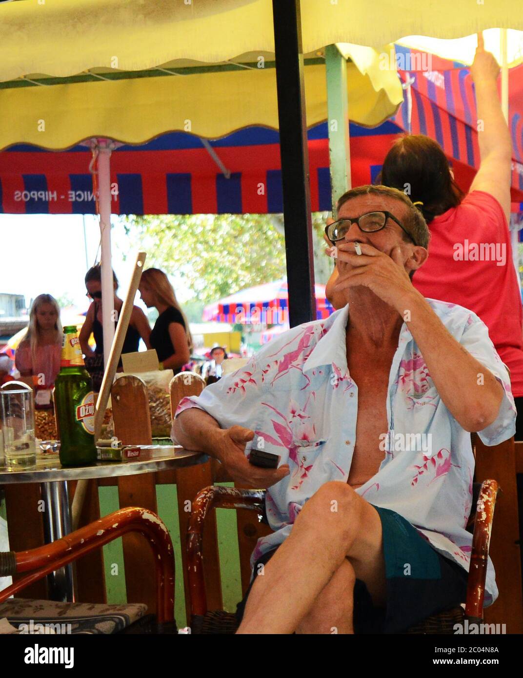 A Croatian man smoking a cigarette and drinking a traditional cup of coffee  Stock Photo