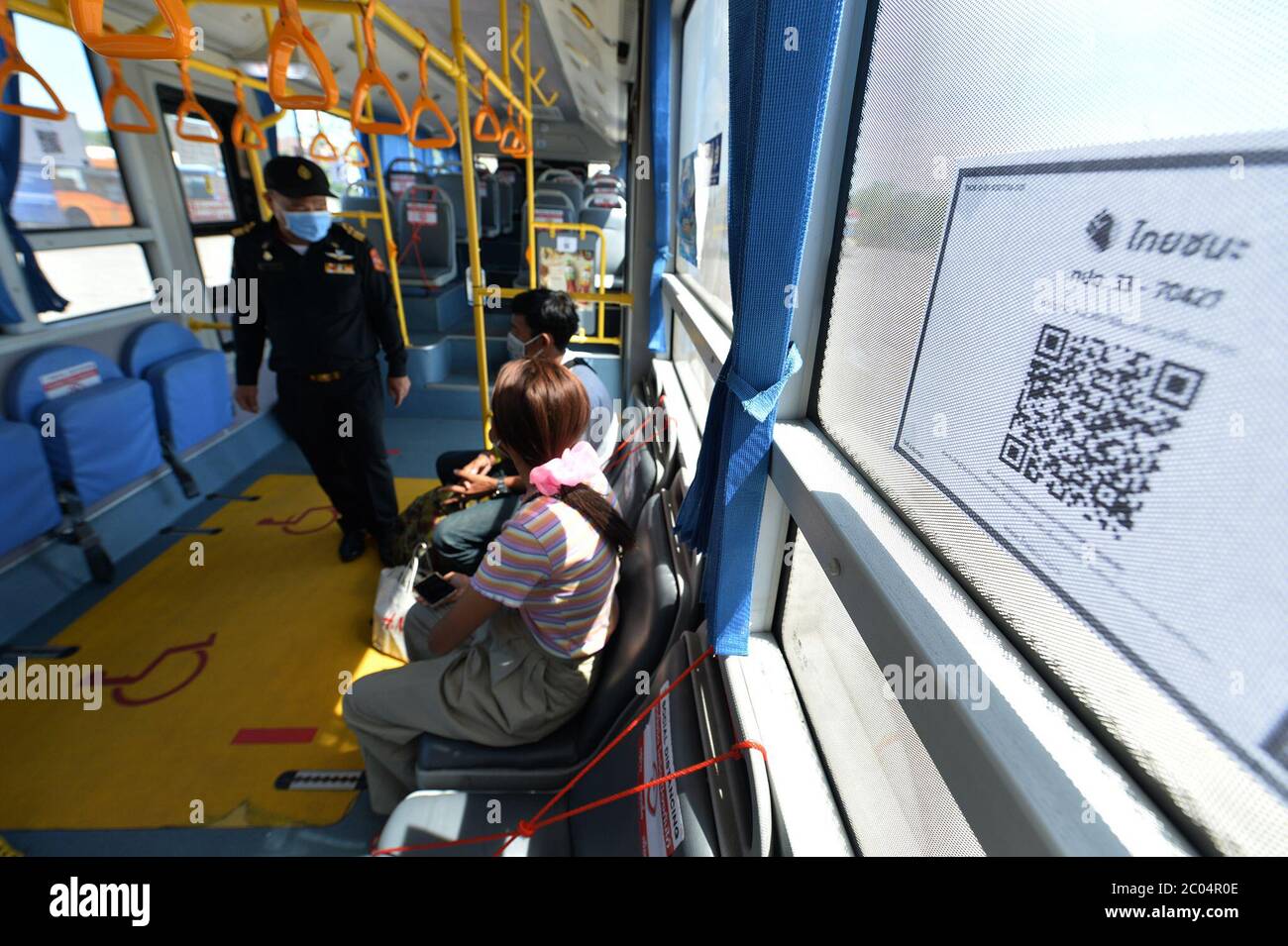 (200611) -- BANGKOK, June 11, 2020 (Xinhua) -- Passengers take a bus in Bangkok, Thailand, June 11, 2020. Bus passengers in Thailand are required to check-in via a government tracking app every time they travel starting on Thursday. The mobile phone QR scanning system has been used on buses as a measure to prevent a further outbreak of the COVID-19 pandemic. (Xinua/Rachen Sageamsak) Stock Photo