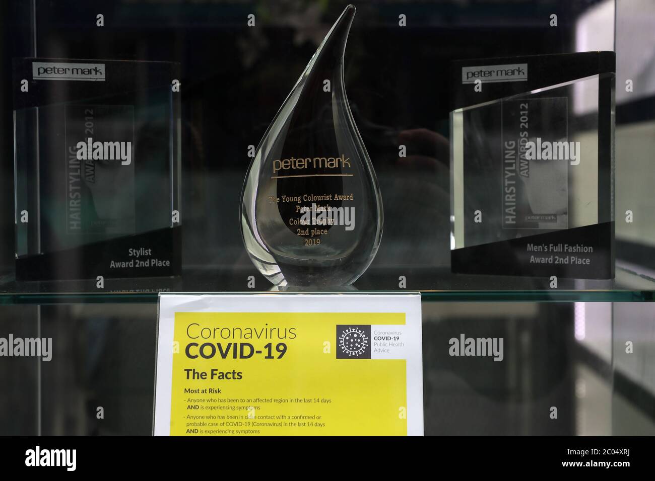 Information on coronavirus alongside a hair dressing award in a shop window on Grafton street in Dublin as hairdressers may be allowed to reopen earlier than previously planned as lockdown restrictions continue to be lifted. Stock Photo