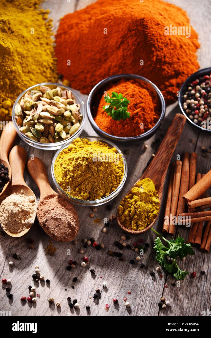 Variety of spices on wooden kitchen table Stock Photo - Alamy