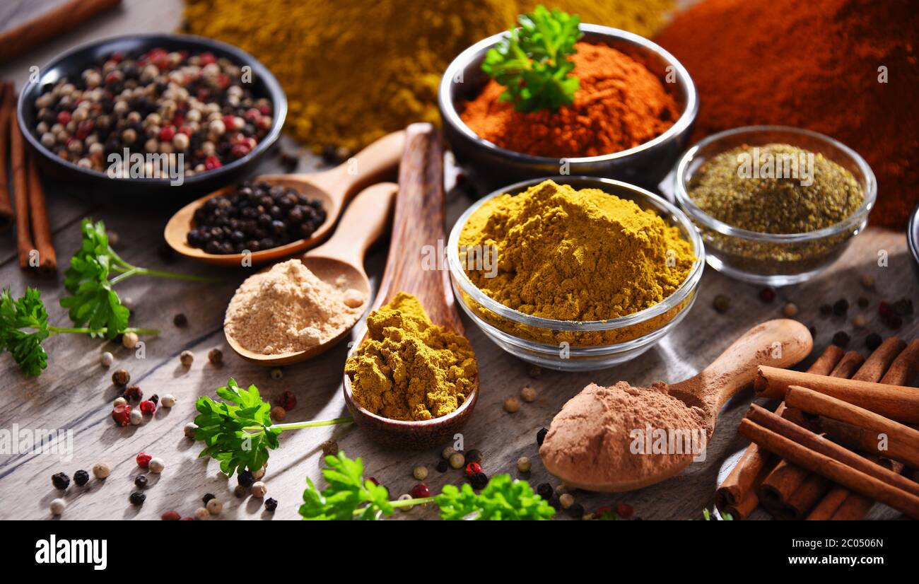 Variety of spices on wooden kitchen table Stock Photo - Alamy
