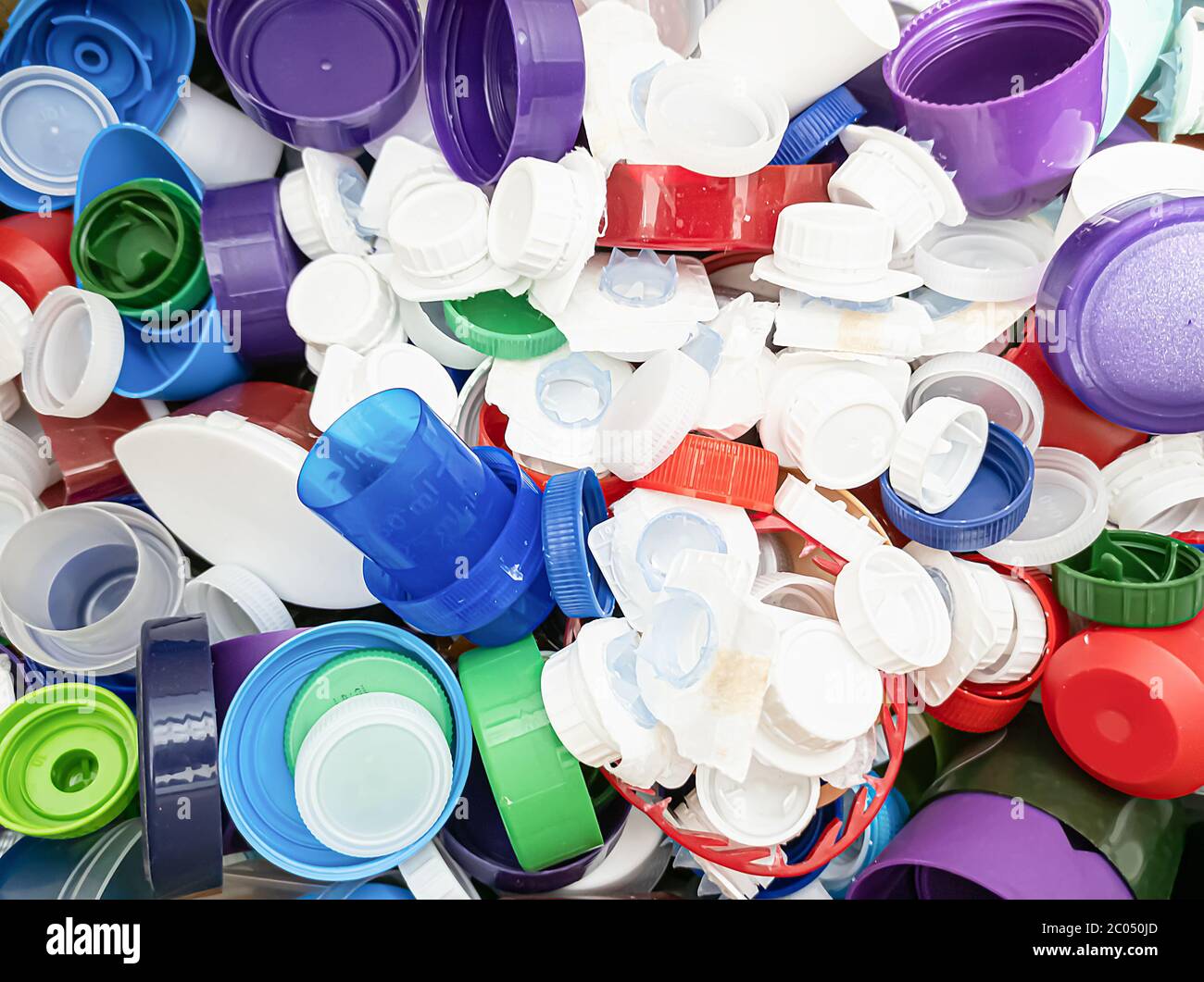 Plastic bottle caps of assorted colors and sizes ready for recycle Stock Photo