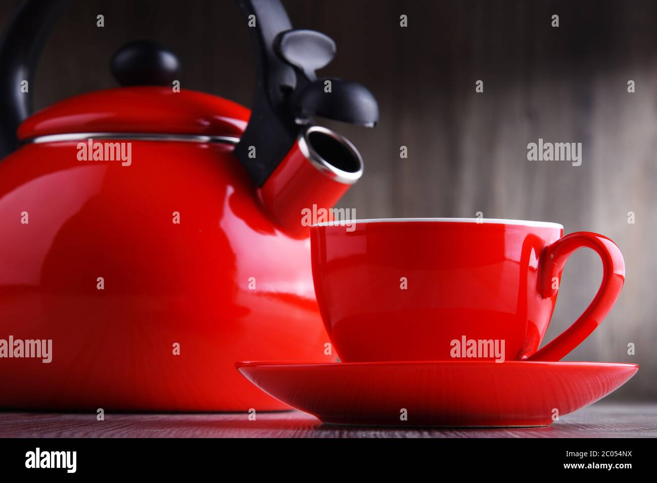 Cup of coffee and stainless steel stovetop kettle with whistle. Stock Photo