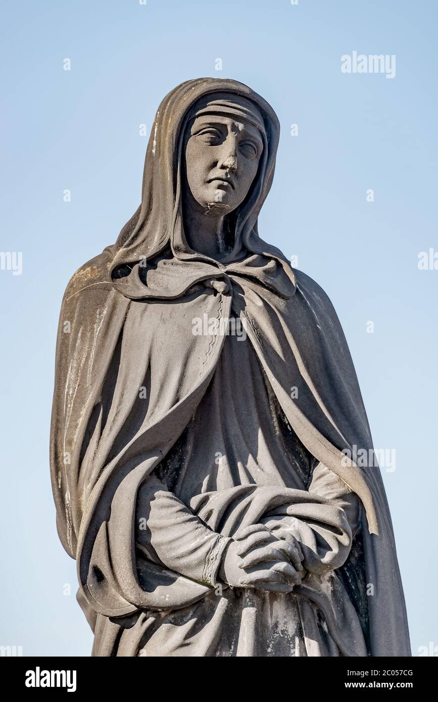 Statue of nun at the Charles Bridge in Prague, Czech Republic, summer