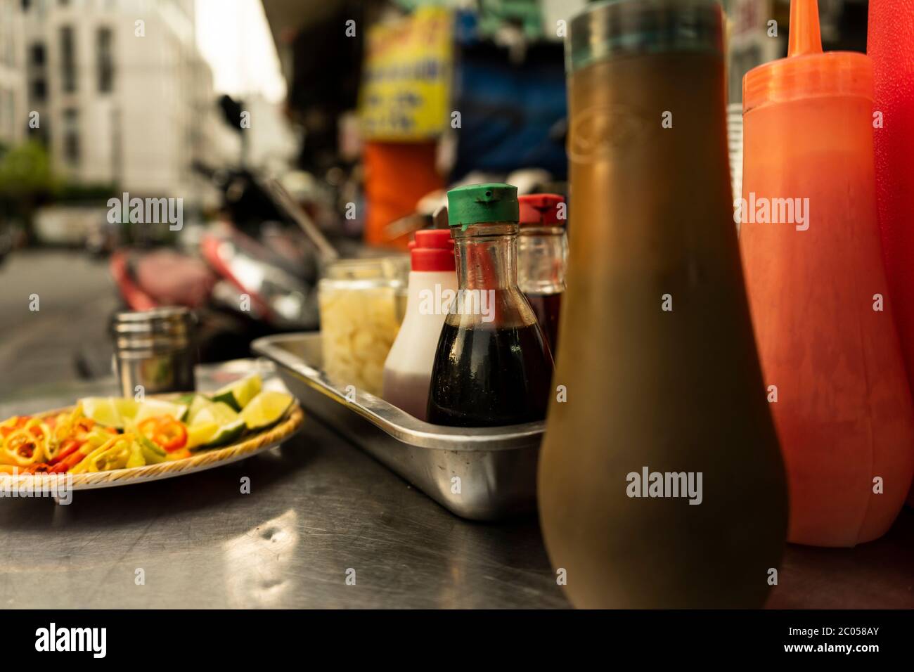 Traditional Vietnamese noodle condiment tray with dish of lemon slices