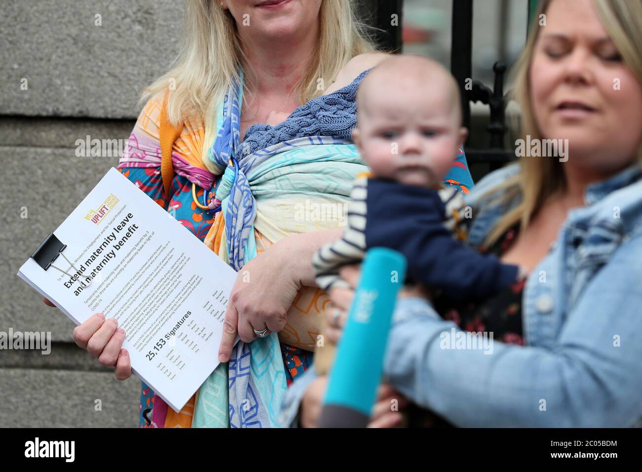 Paula Solan holds a petition for Taoiseach Leo Varadkar calling for an extension of maternity leave for 3 months due to the Covid-19 crisis at Leinster House in Dublin. Stock Photo