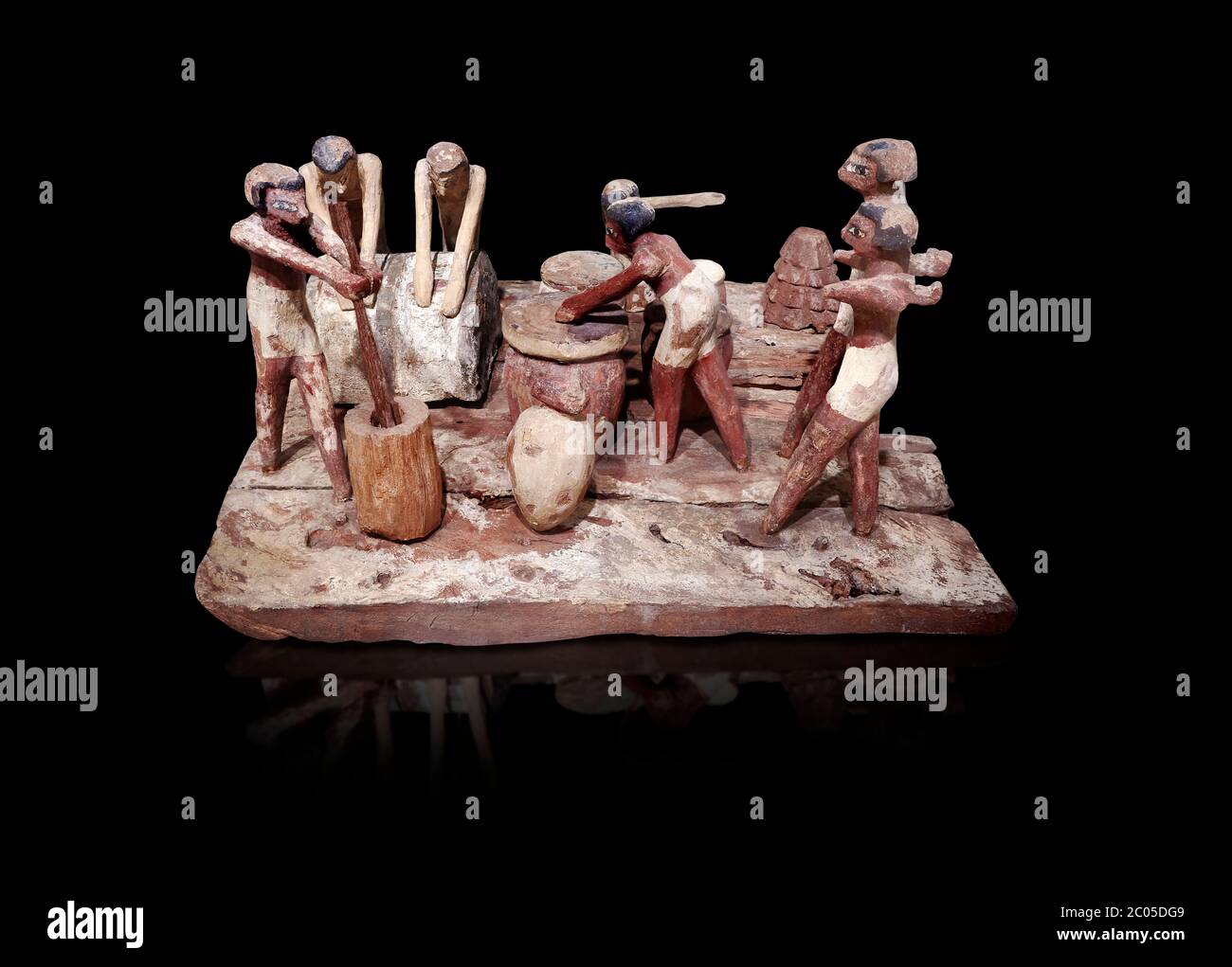 Ancient Egyptian wooden model of bread making, Middle Kingdom, (1939-1875 BC),  Egyptian Museum, Turin.   black background.   Wooden tomb models were Stock Photo