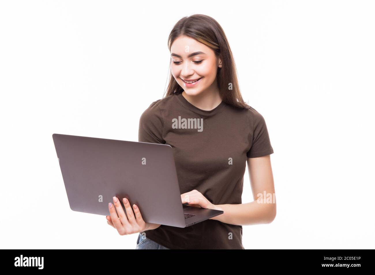Young female working on laptop isolated on white background Stock Photo ...