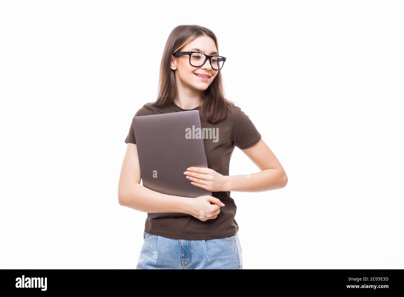 Portrait of a smiling girl holding laptop computer isolated on a white ...