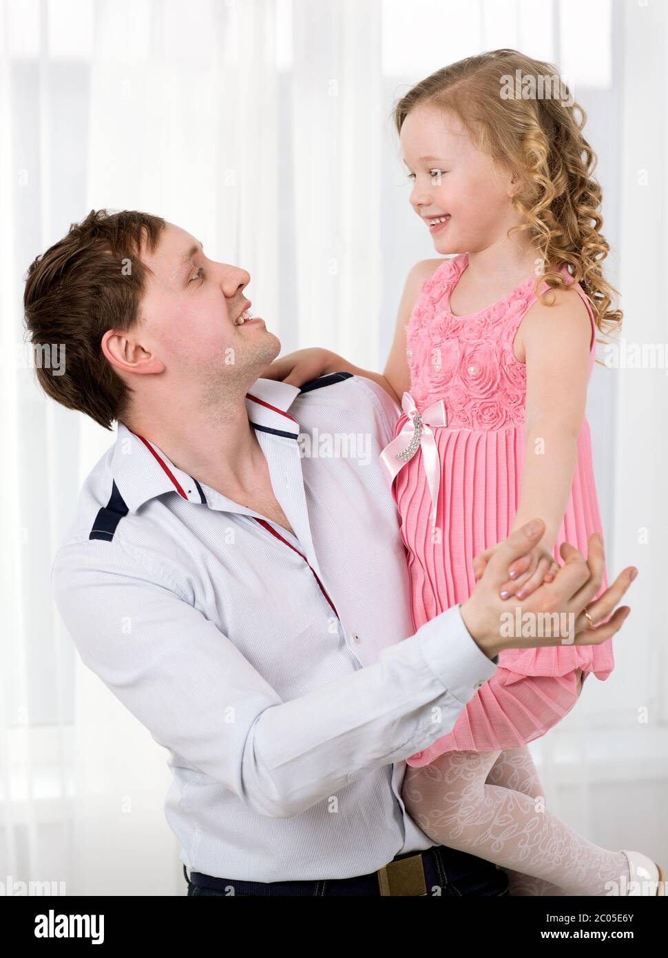 Father holding daughter and they dancing Stock Photo