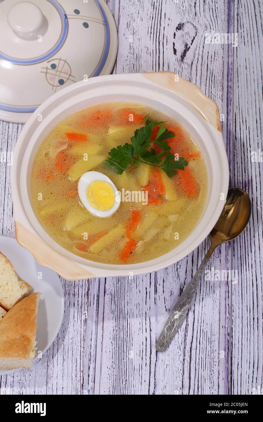 Chicken soup with noodles and egg Stock Photo - Alamy