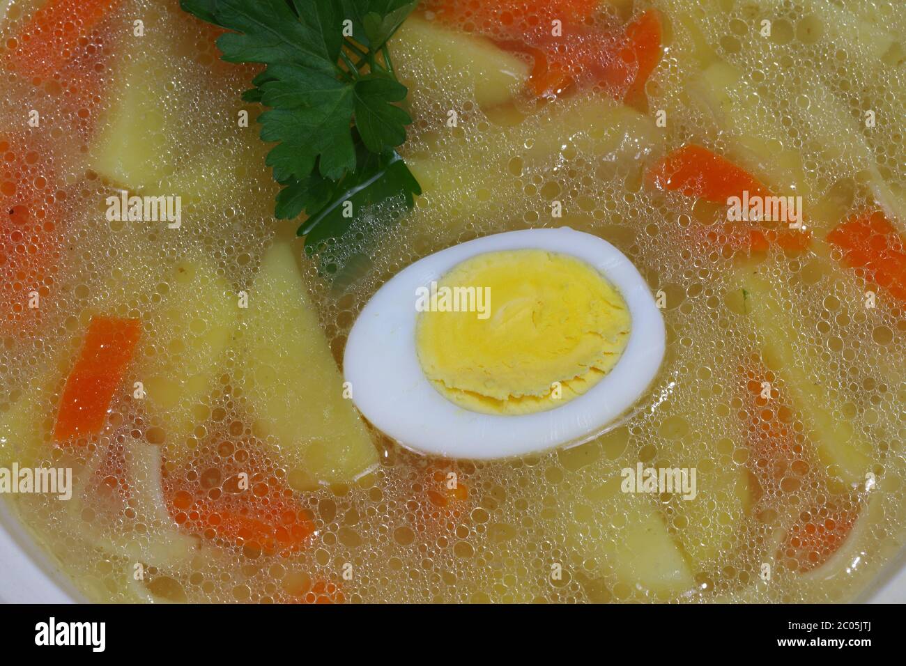Chicken soup with house noodles and boiled egg Stock Photo