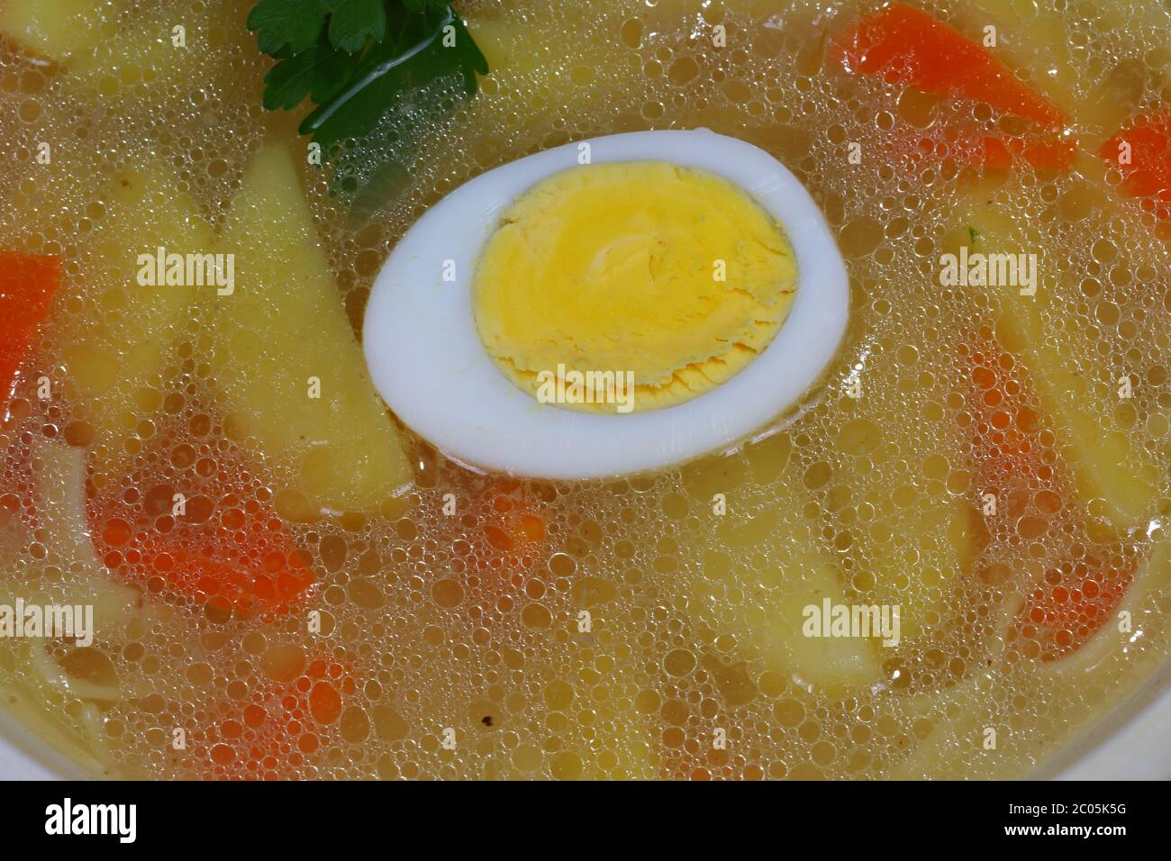 Chicken soup with house noodles and boiled egg Stock Photo