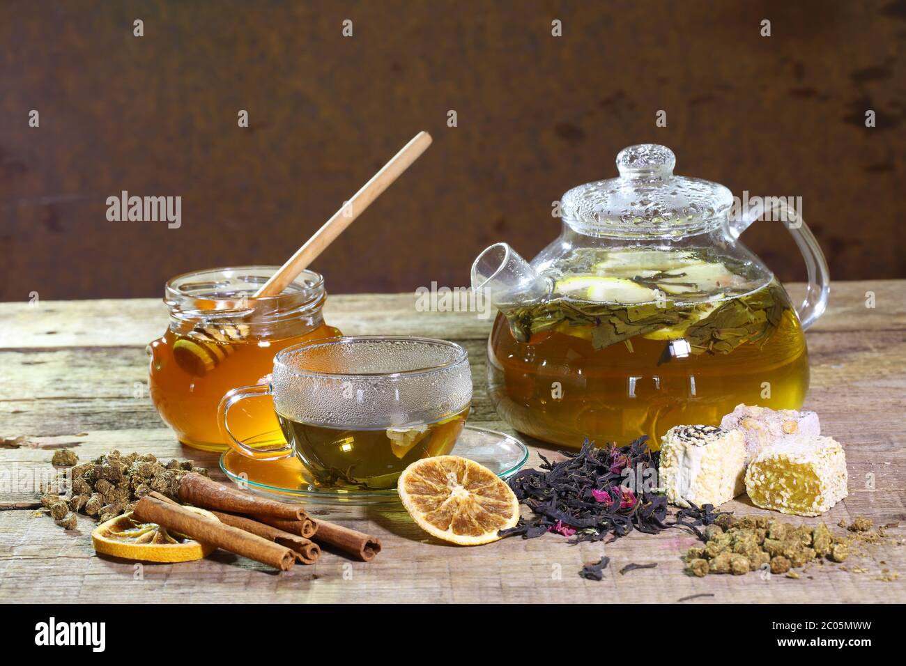 Teapot with green tea and honey in transparent bank Stock Photo