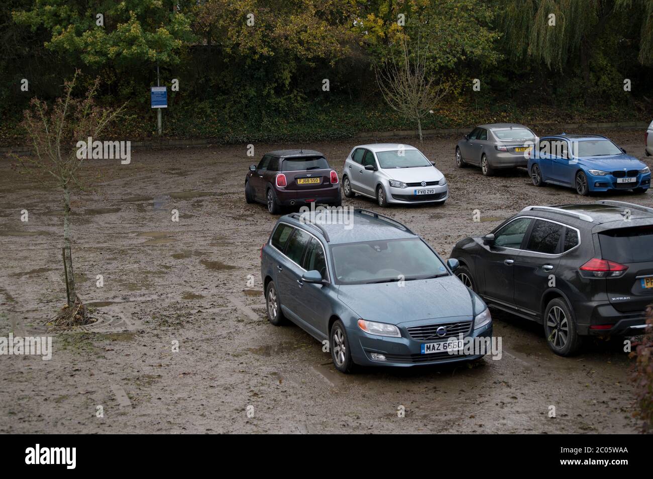 Vehicles in a muddy car park after floods have subsided in Market Harborough, Leicestershire, England. Stock Photo