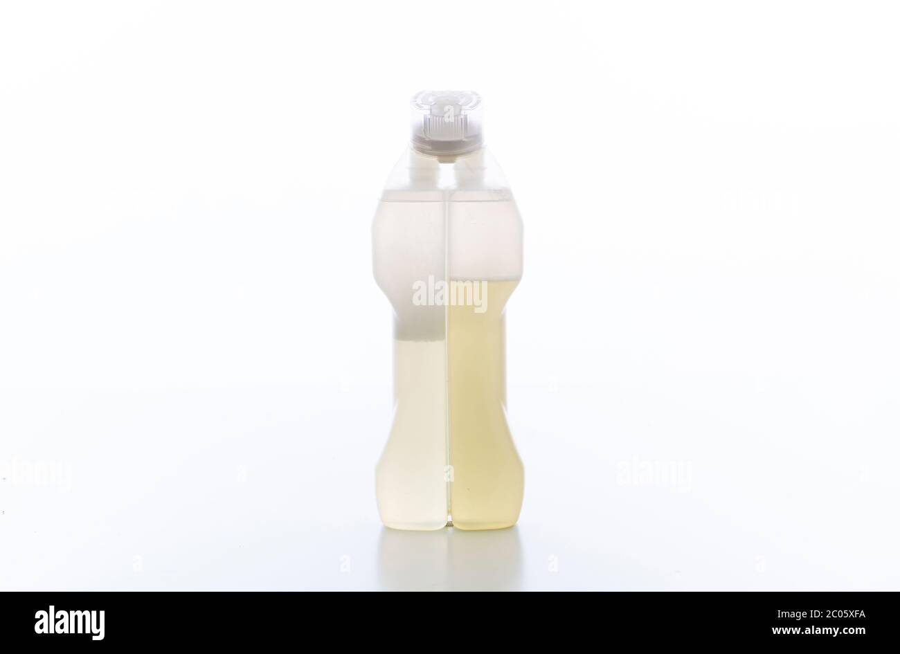 Cleaning carpet product isolated against white background. Chemical detergent clear bottle with two compartments, two components. Stock Photo