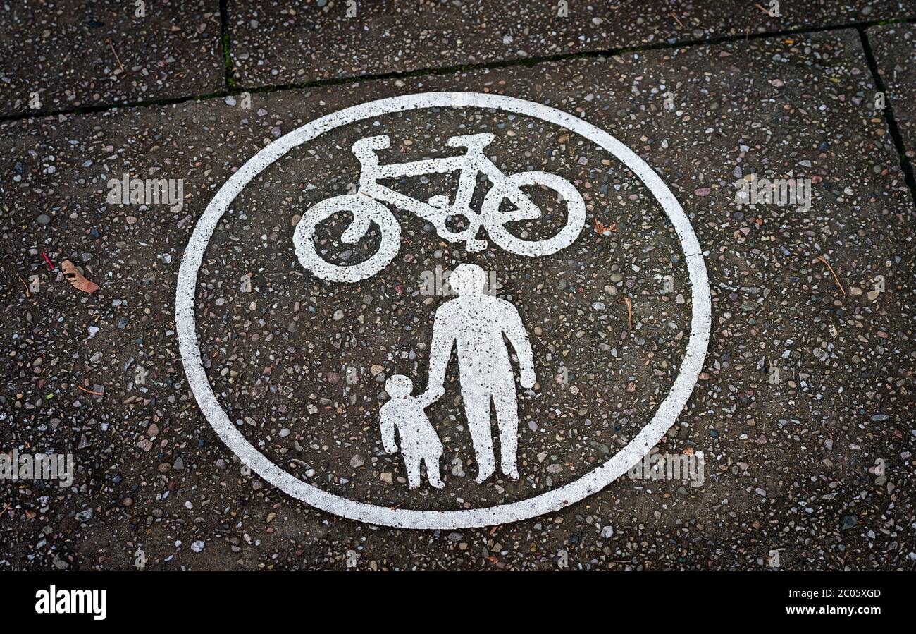 Sign on a pavement showing a cycling and pedestrian lane. Stock Photo