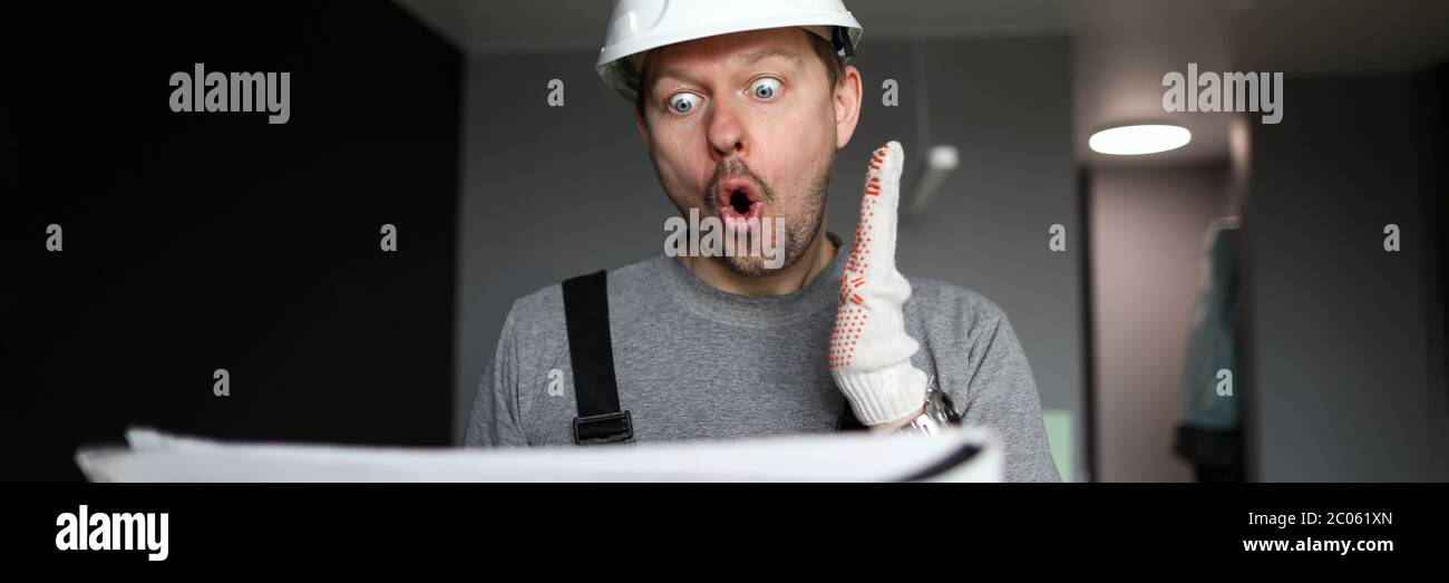 Shocked handyman or engineer looking at scheme Stock Photo