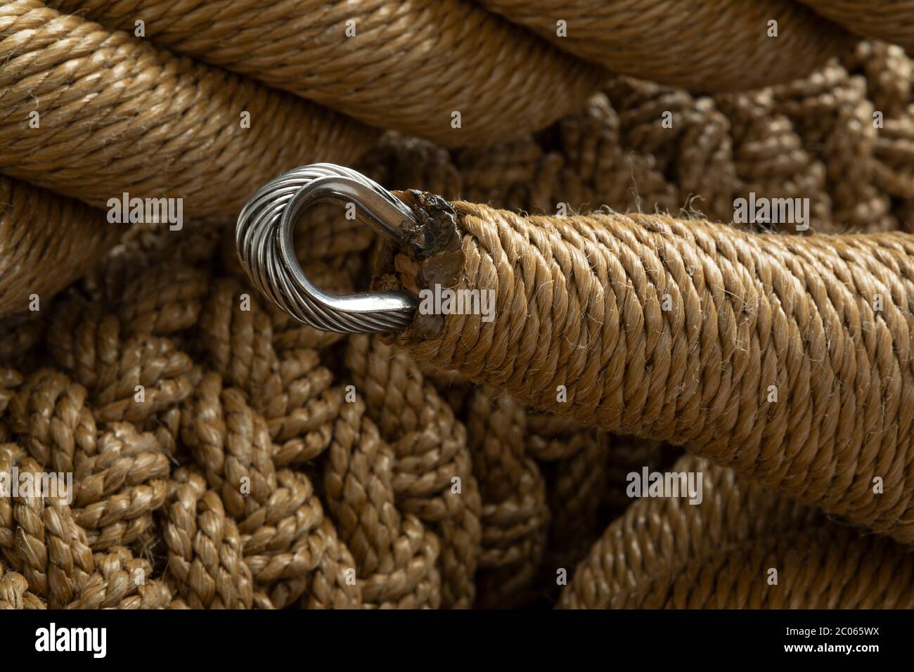 New handmade knotted rope close up full frame with a metal ring Stock Photo